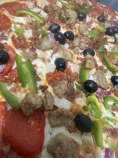 Supreme pizza with sausage, peppers and black olives