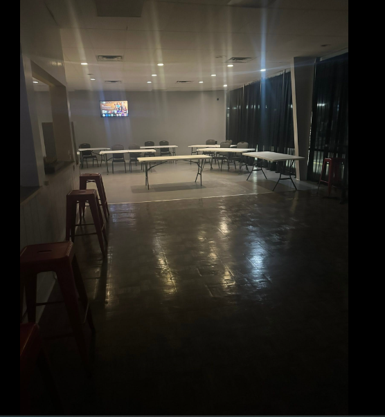 The Spot on 10th private event space with red stools and warm spotlights