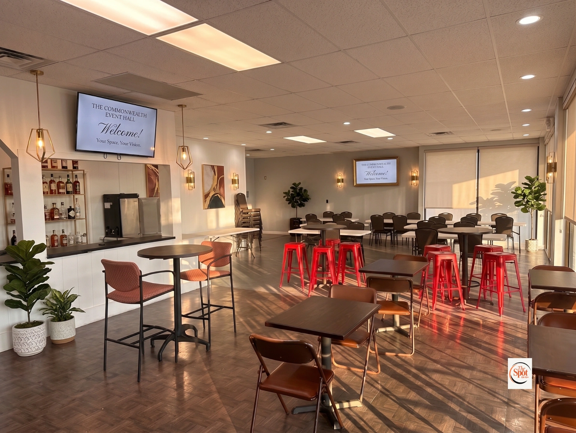 The Spot on 10th event hall with modern seating, bar area, and warm natural lighting